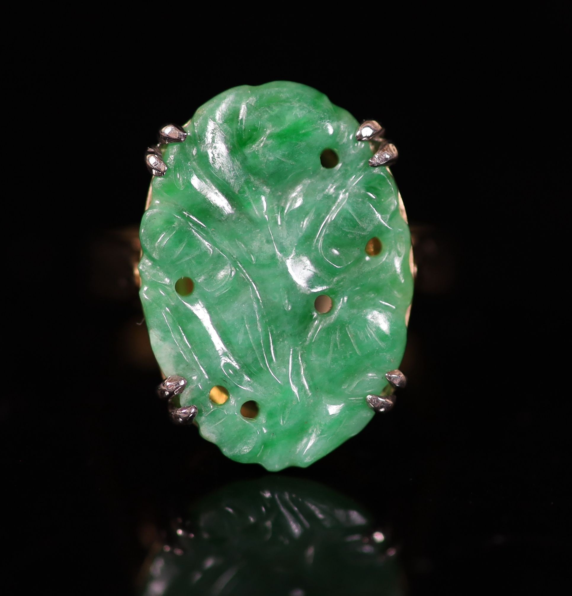 A mid 20th century yellow metal and carved oval jade set dress ring